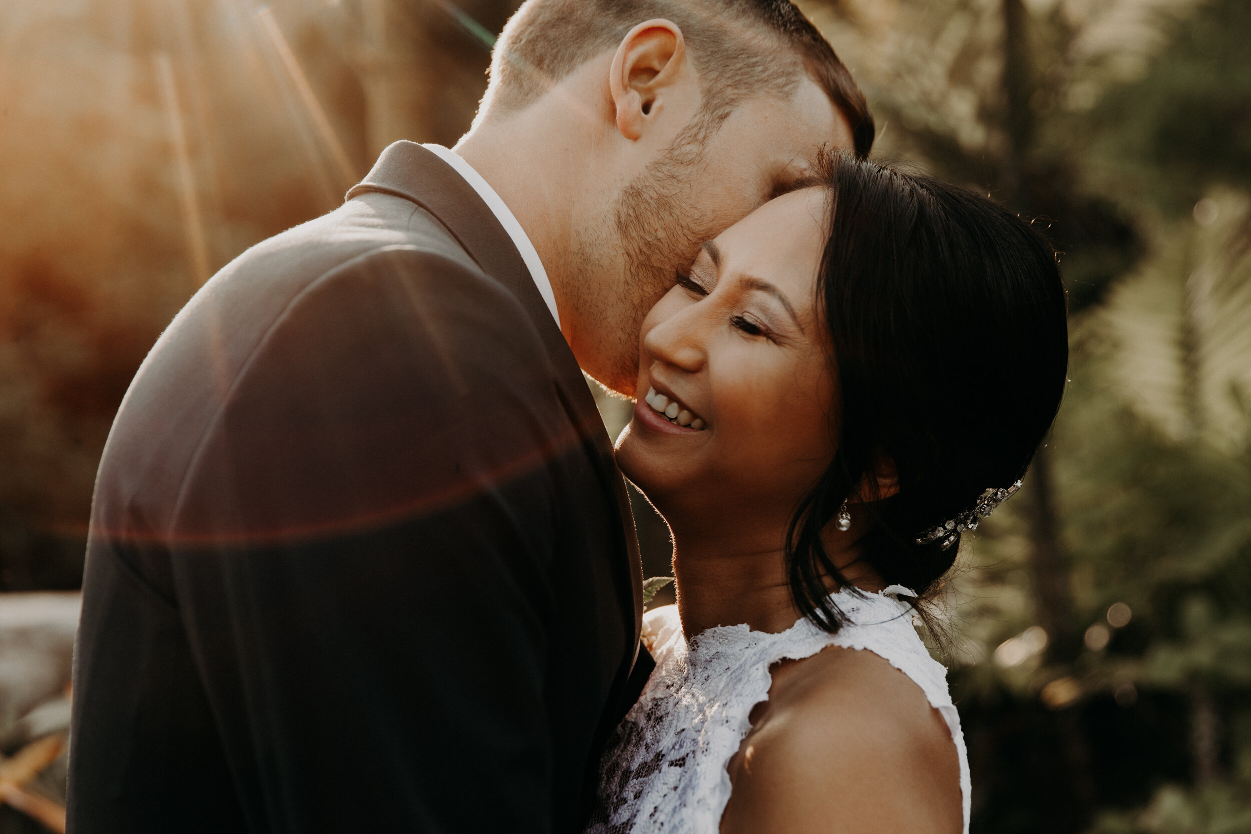 couple enjoying their wedding day while staying relaxed, smiling, and embracing one another