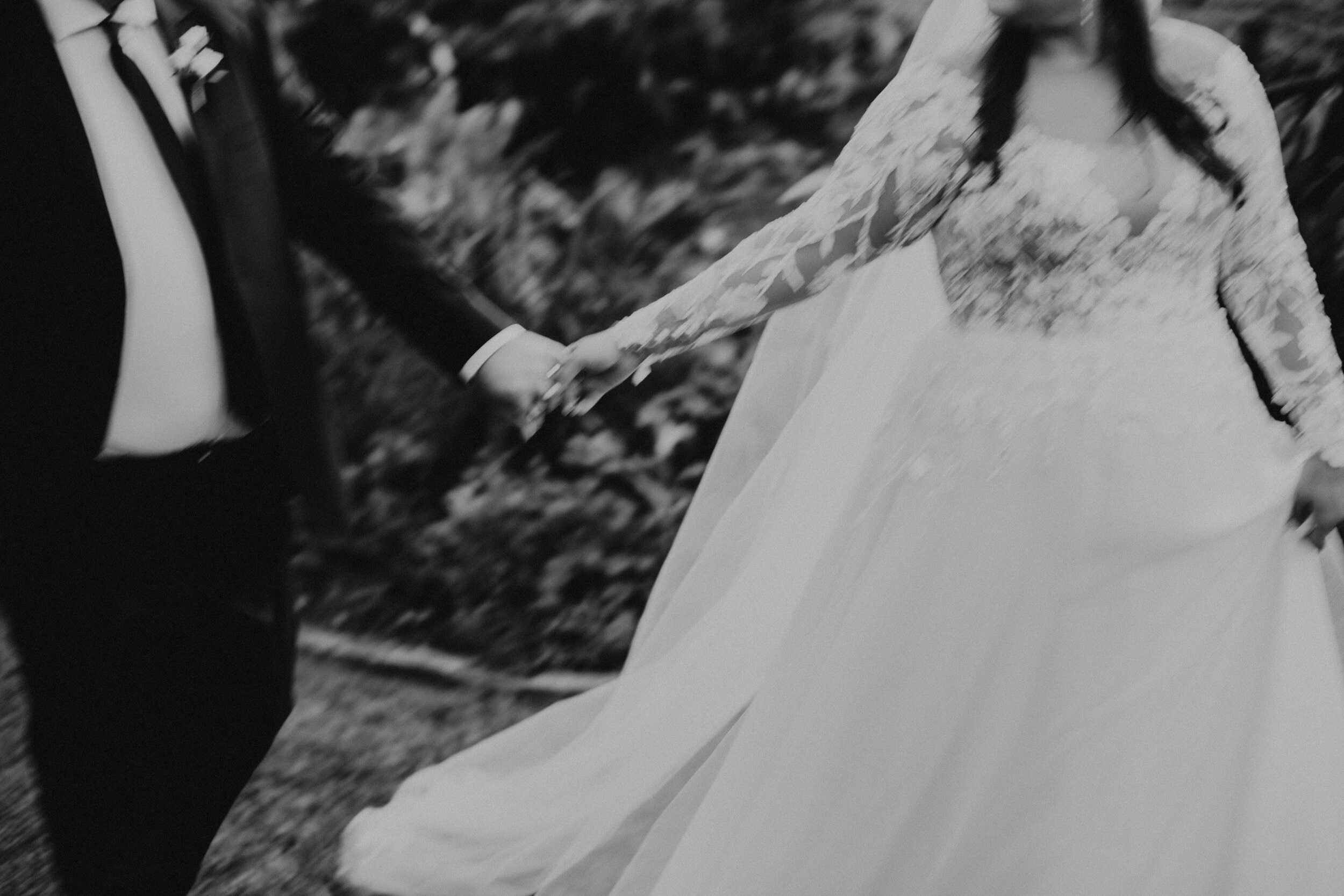 blurry black and white photo of newlyweds enjoying their wedding day